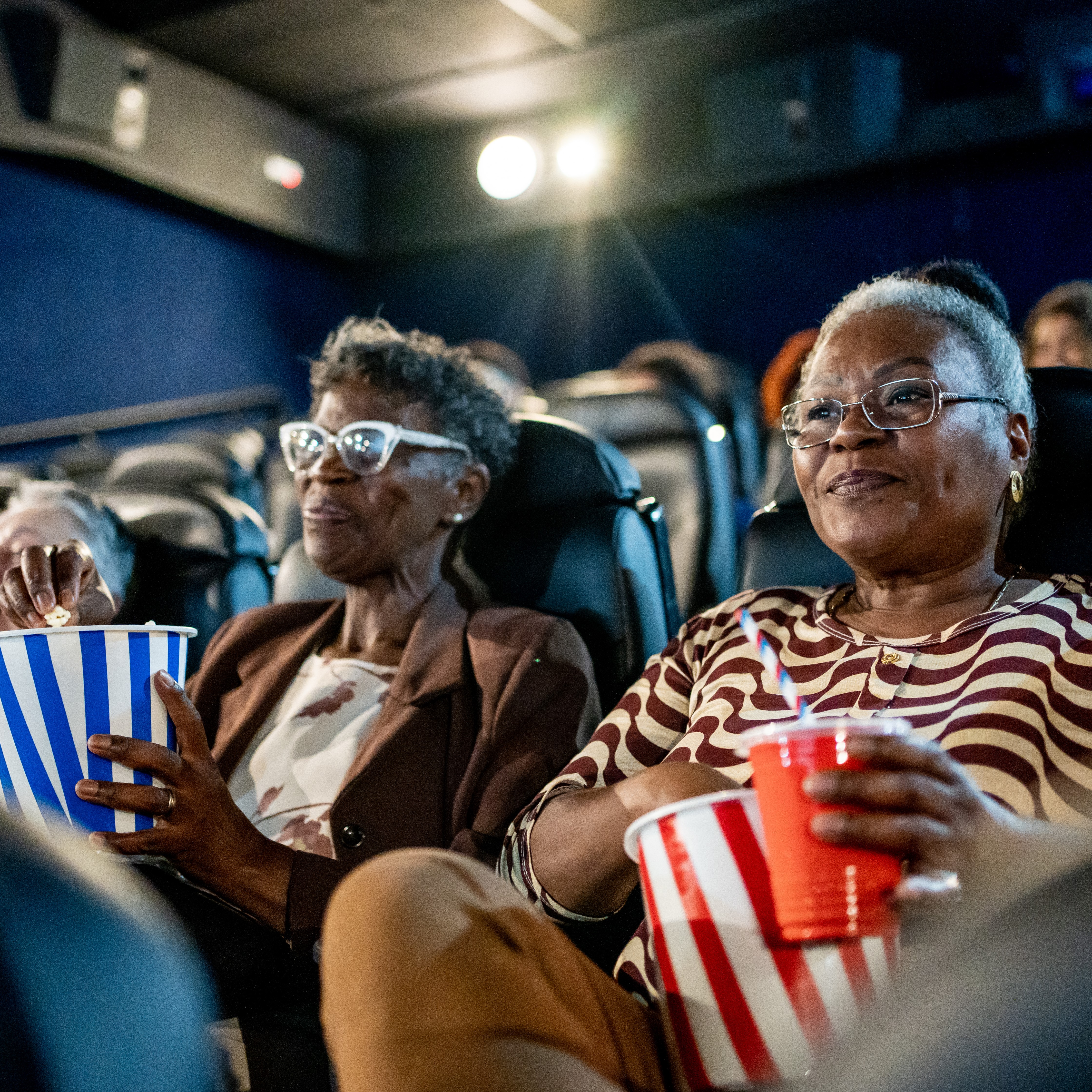 active adults watching a movie | Amare Vita 55 plus communities
